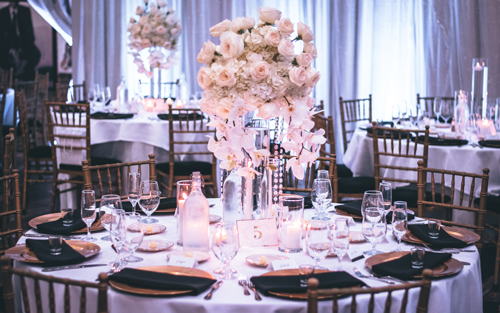 A tastefully and affordably decorated reception area featuring small bouquets and simple place settings