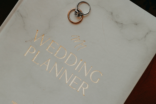 filling out a document titled wedding budget planner.